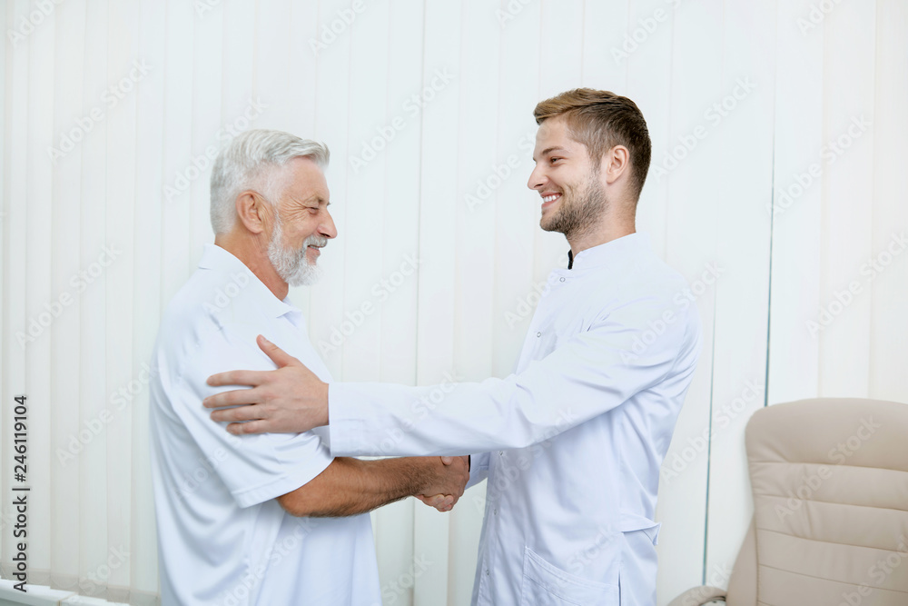Portrait of two smiling specialist shaking hands. Portrait of two smiling specialist shaking hands.