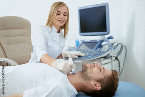 Smiling nurse working with patient on procedure.