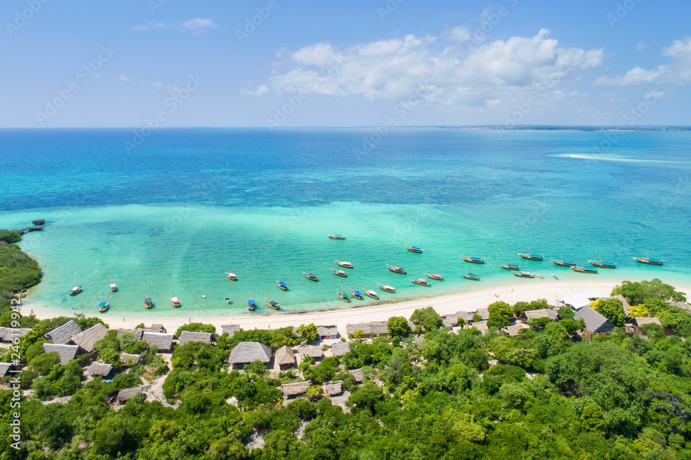 aerial view to green forest and boats at sea on Zanzibar island