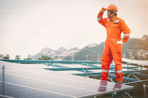 engineer in solar power plant working on installing solar panel ; operation of solar power plant by smart operator