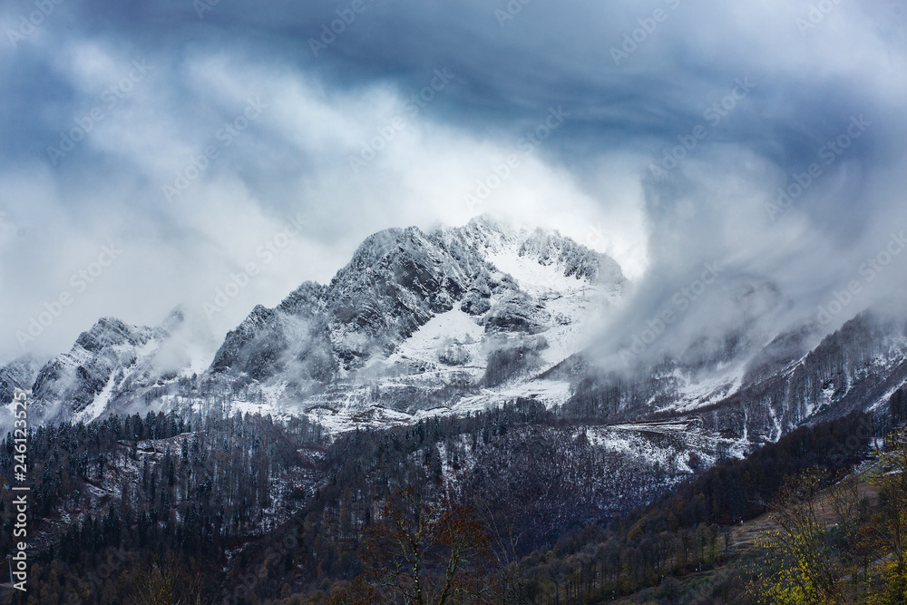 View of beautiful mountain shrouded in blue clouds View of beautiful mountain shrouded in blue clouds