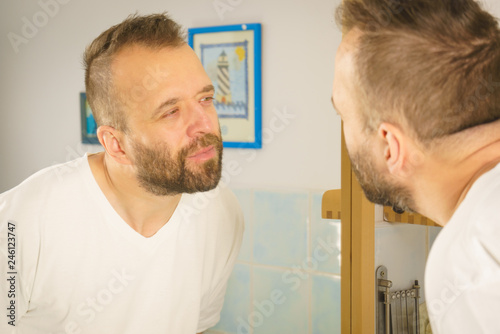 Man looking at himself in mirror