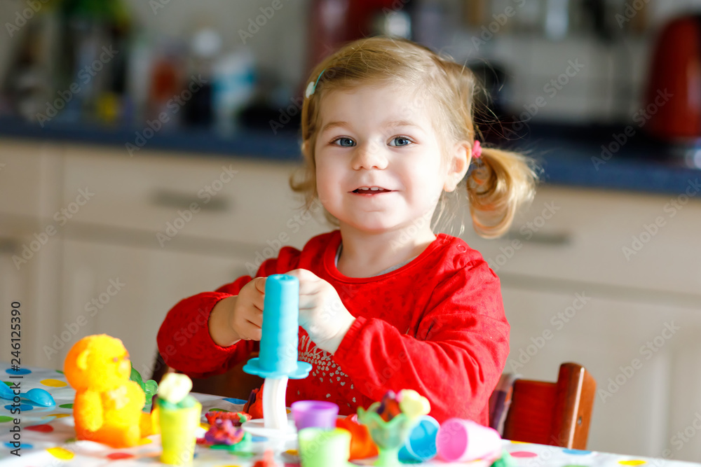 Adorable cute little toddler girl with colorful clay. Healthy baby ...