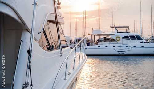 View of harbor with yachts details. Beautiful sunset sky in the marina bay.