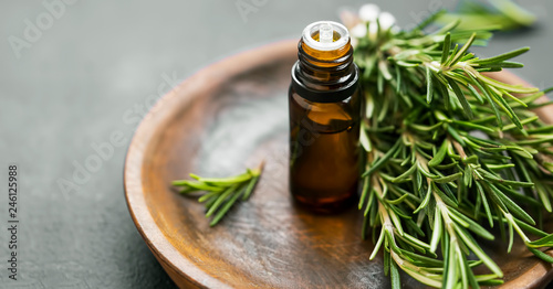 Rosemary essential oil with rosemary herb bunch