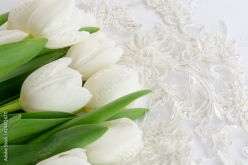 Wedding lace and white tulips on a white background