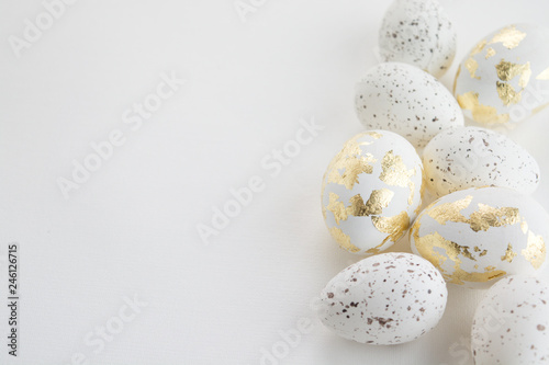 Easter eggs and feathers on a white background