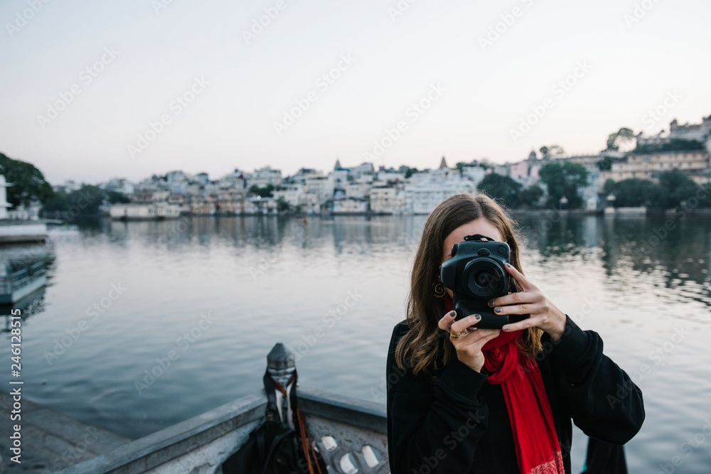 Western woman capturing a city view of Udaipur, India