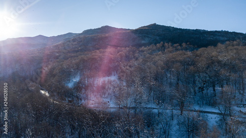 Aerial view of snow capped mountains during sunset. Location place Psebai, Russia. photo