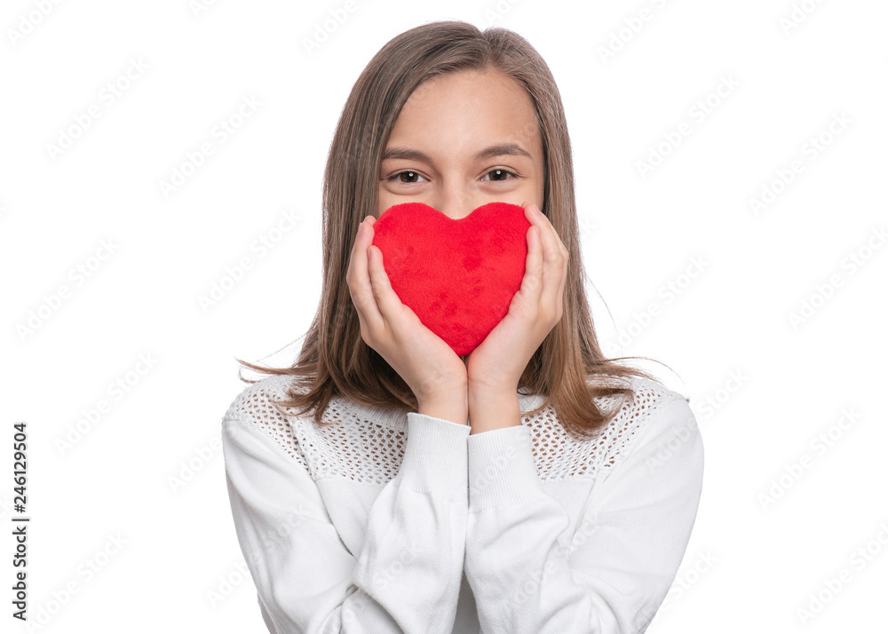 Happy Valentines Day. Cute young Teen Girl in Love with Red plush Heart in her hands. Smiling Child looking at camera, isolated on white background. Happy Valentines Day. Cute young Teen Girl in Love with Red plush Heart in her hands. Smiling Child looking at camera, isolated on white background.