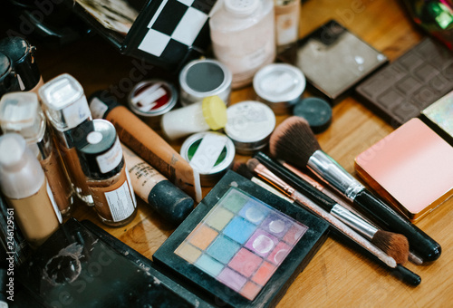 Collection of makeup products on a dressing table