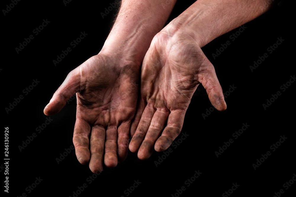 Fototapeta premium Dirty hands isolated on black background. Begging hands.