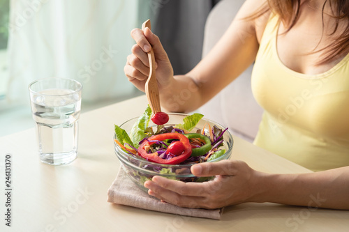 Young woman eating homemade healthy salad at home  Healthy lifestyle  diet concept