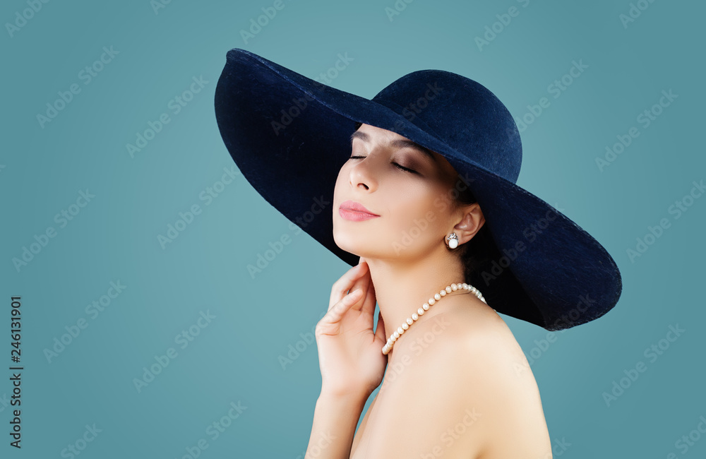 Sensual woman fashion model in hat on blue background with copy space Sensual woman fashion model in hat on blue background with copy space