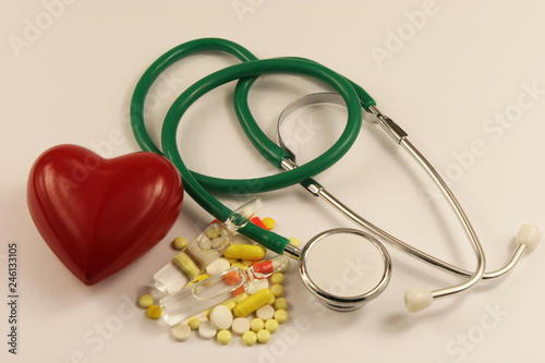 Pharmaceutical medicament, cure in container for health, stethoscope and heart on white background.