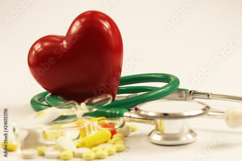 Pharmaceutical medicament, cure in container for health, stethoscope and heart on white background.