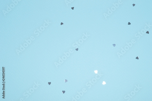 Silver glitter hearts on blue background in vintage colors