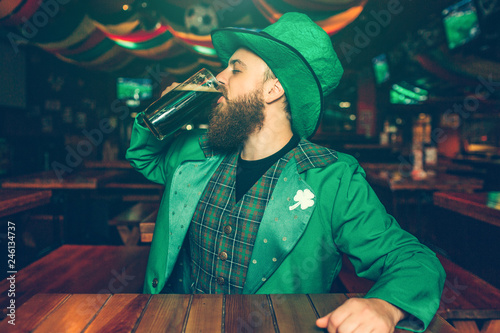 Photos One young man sitting alone at table in pub