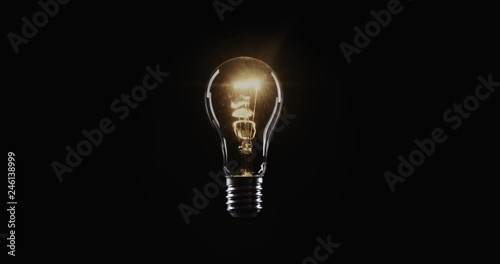 Flickering Tungsten light bulb lamp over black background