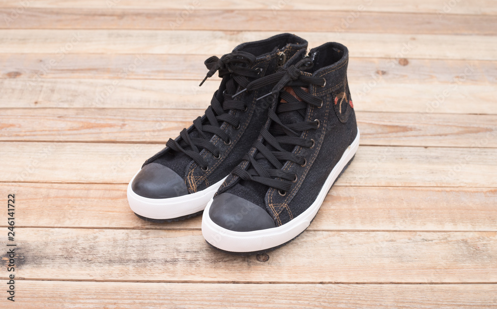 Sneaker style Canvas shoes at wood background Sneaker style Canvas shoes at wood background
