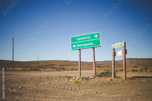Photography Wide angle view of roadsigns on a dirtroad, in the karoo region of south africa,