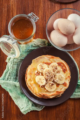 Thin pancakes with banana, walnuts and honey