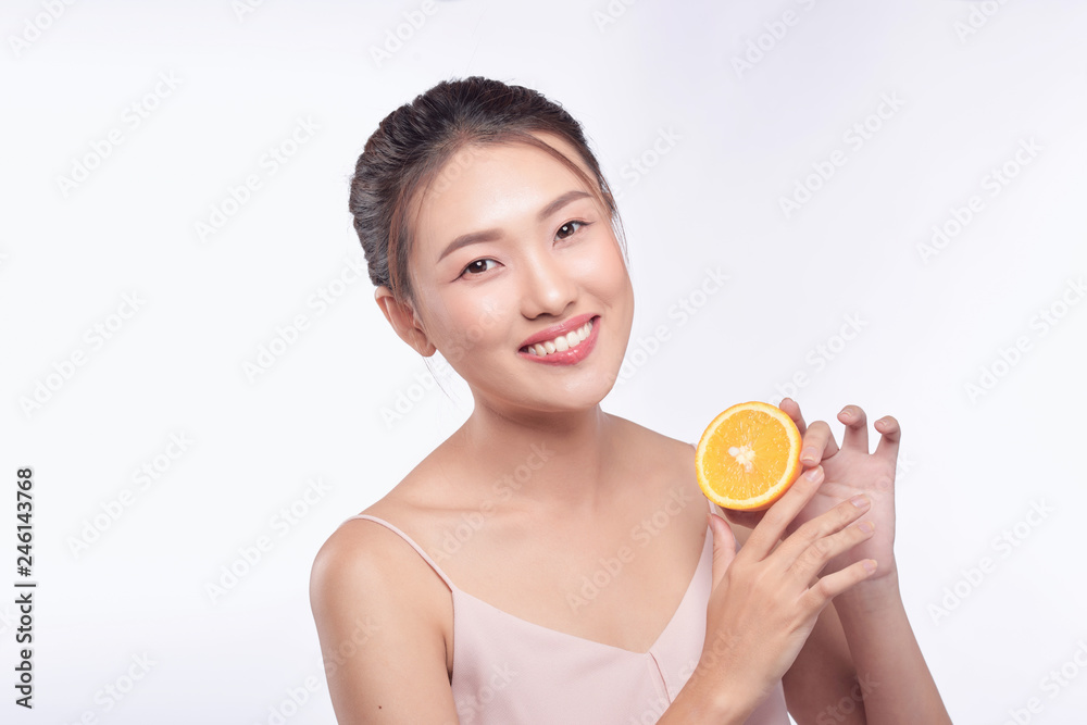 Young asian woman with orange in her hands isolated on white background Young asian woman with orange in her hands isolated on white background