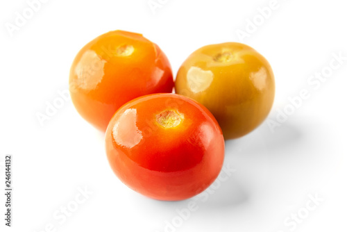 Pickled tomatoes isolated on white background.