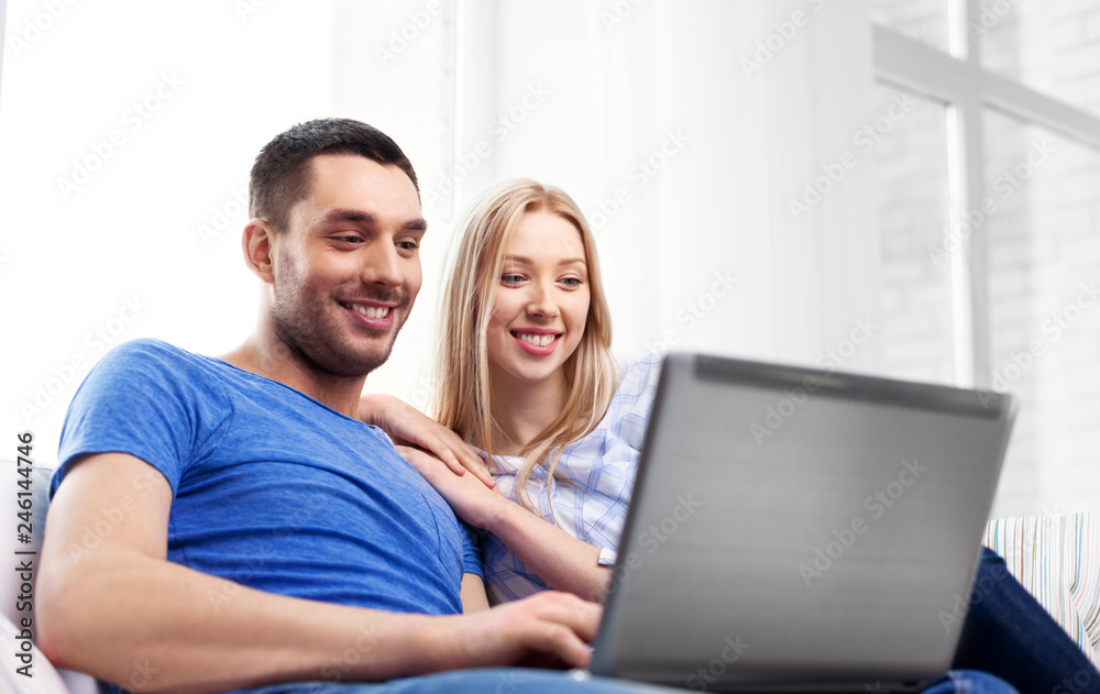 technology, internet and people concept - happy couple with laptop computer at home technology, internet and people concept - happy couple with laptop computer at home