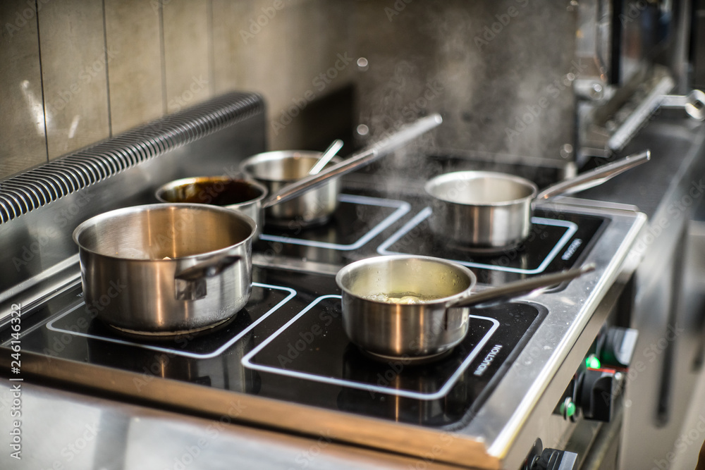 Pots on the stove in the restaurant. Cooking food. Pots on the stove in the restaurant. Cooking food.