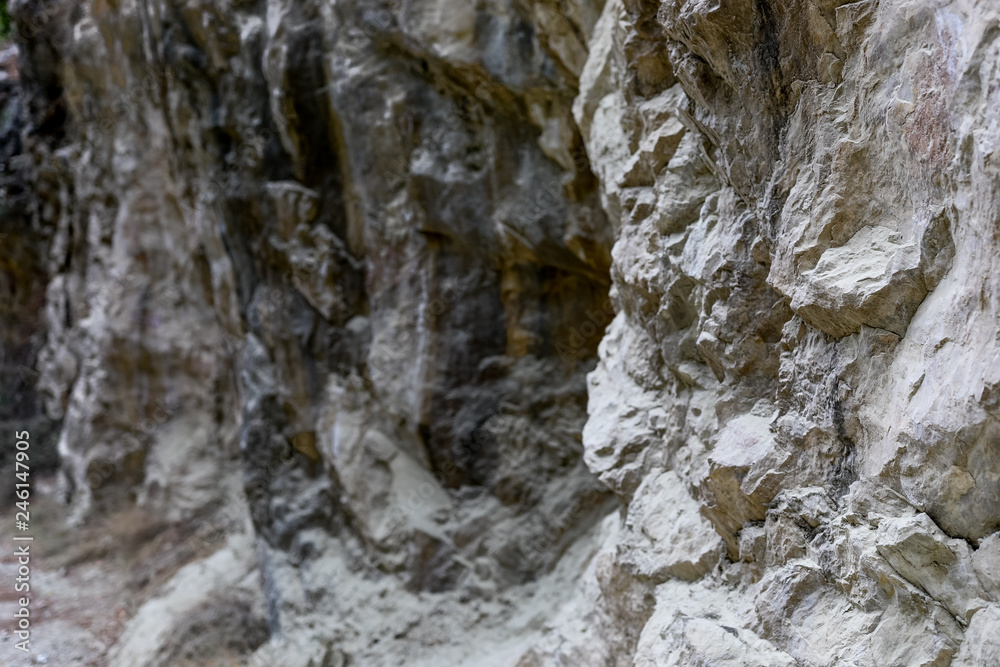 Natural stony background of part of rock formation with uneven surface. 