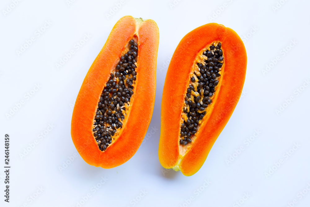 Half of ripe papaya fruit with seeds isolated on white background