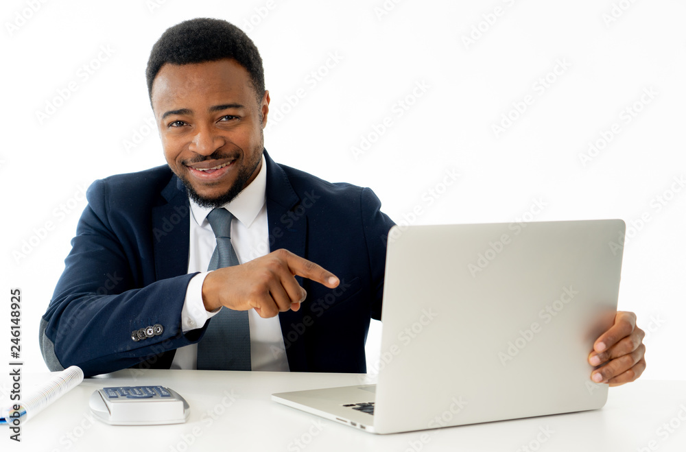 Attractive happy handsome african american businessman working on laptop computer on desk at office Attractive happy handsome african american businessman working on laptop computer on desk at office