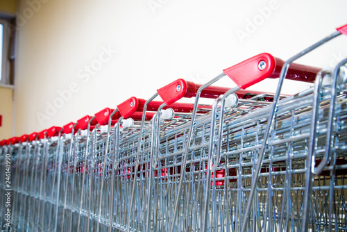 Many empty shopping carts in a row. Grocery carts