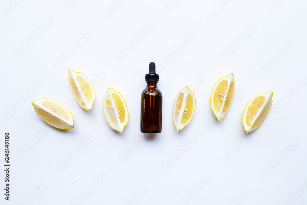 Bottle with lemon essential oil on white Bottle with lemon essential oil on white
