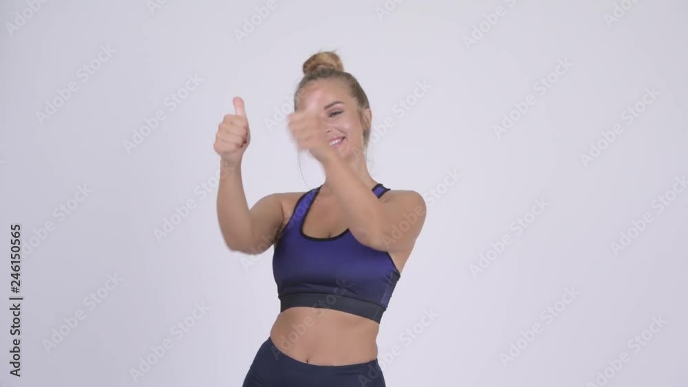 Happy young blonde woman looking excited while giving thumbs up Happy young blonde woman looking excited while giving thumbs up