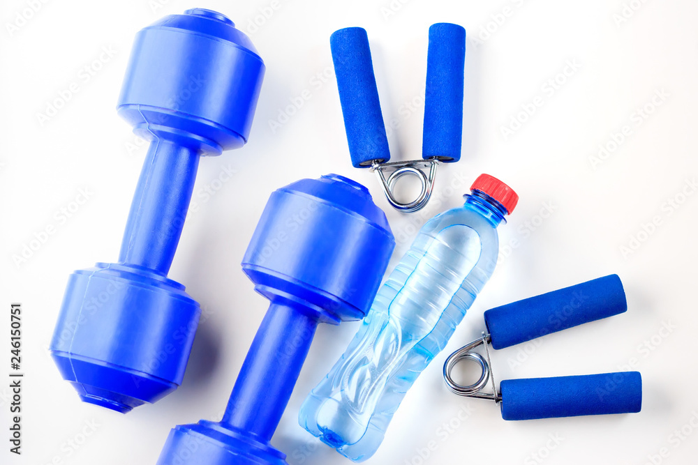 A bottle of water and sports equipment on a white background A bottle of water and sports equipment on a white background