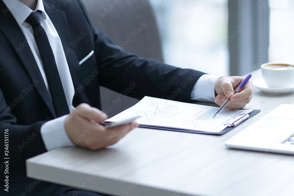 closeup.businessman checking financial statement,sitting at the Desk closeup.businessman checking financial statement,sitting at the Desk