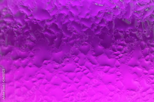 Macro shot of the condensation on the vivid purple glass bottle 