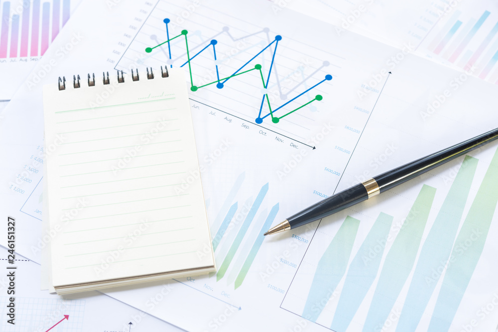 Notebook and Pen with Business Graphs finance document. Notebook and Pen with Business Graphs finance document.