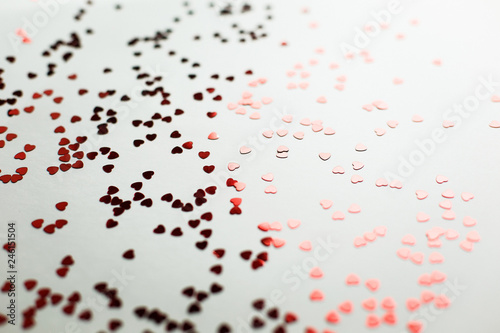 Fototapeta Naklejka Na Ścianę i Meble -   Beautiful background for a wedding or Valentine's Day. Small red heart-shaped blisters scattered on a white background macro shot, soft focus