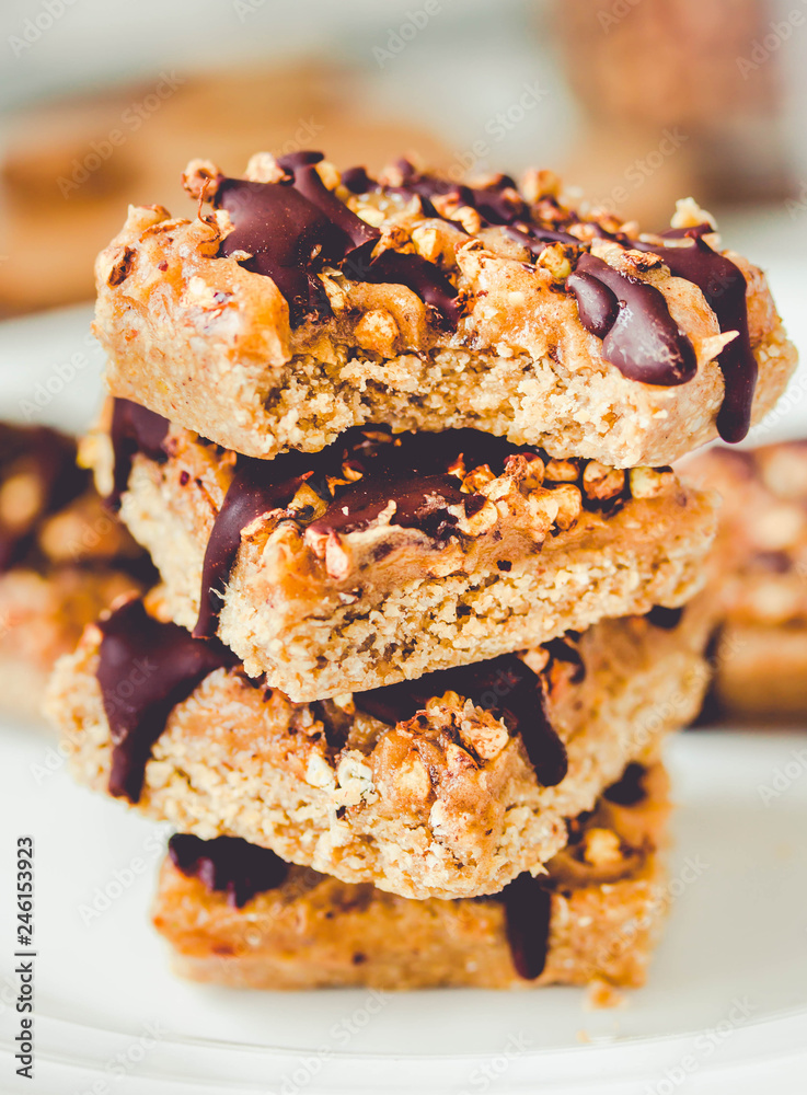 Organic homemade granola bars with date caramel and chocolate on white marble background.Close-up.Tone. Organic homemade granola bars with date caramel and chocolate on white marble background.Close-up.Tone.