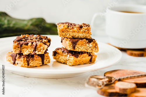 Raw vegan cake with chocolate, a stack of sliced pieces in a white bowl. Dietic dessert. Healthy vegan food concept.