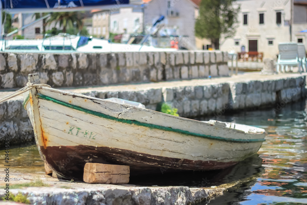 An old wooden boat stands in the port