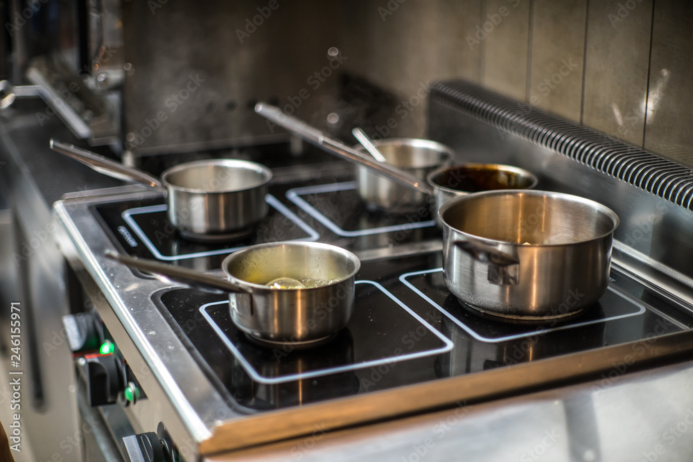 Pots on the stove in the restaurant. Cooking food. Pots on the stove in the restaurant. Cooking food.