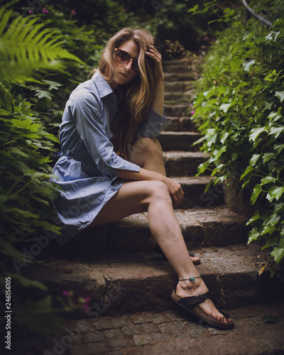 Beautilful young girl posing on stairs outdoors photo