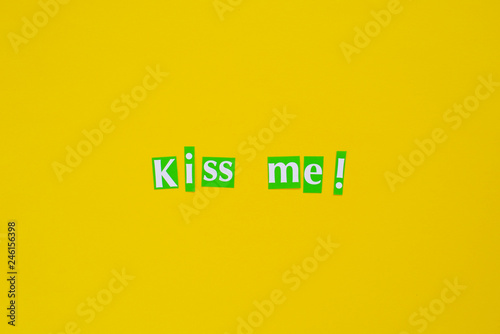 Kiss Me Letters on Yellow Background