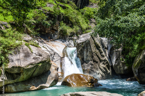 Turquoise blue waterfall in the Great Himalayan National Park also known as GHNP. GHNP is the UNESCO world heritage site & a protected wildlife sanctuary. photo