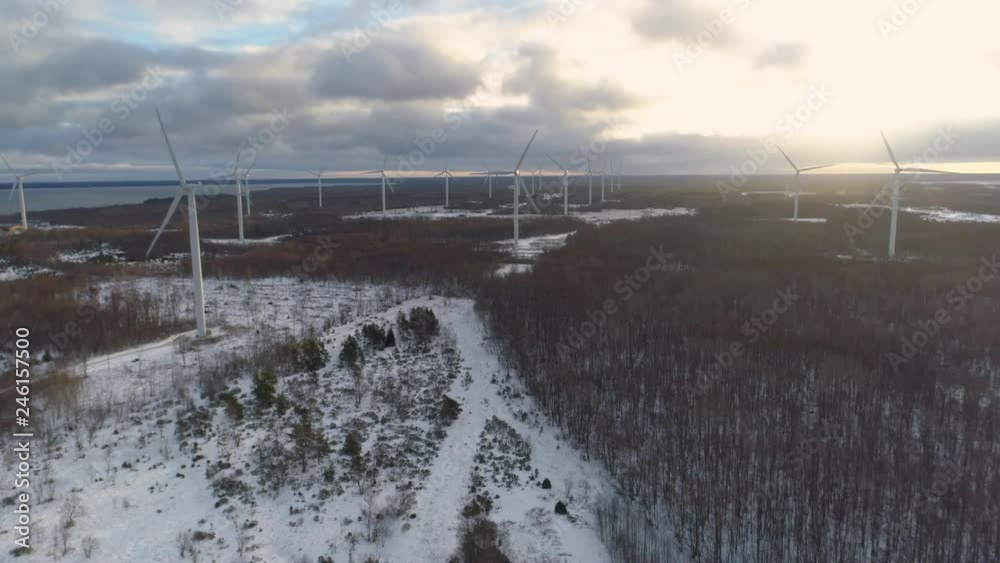 Flying between wind turbines at sunrise aerial view Flying between wind turbines at sunrise aerial view
