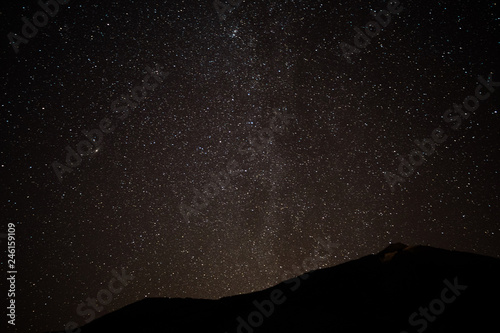 Milky Way. Space filled with stars in the sky. Surrounded by the mountains.